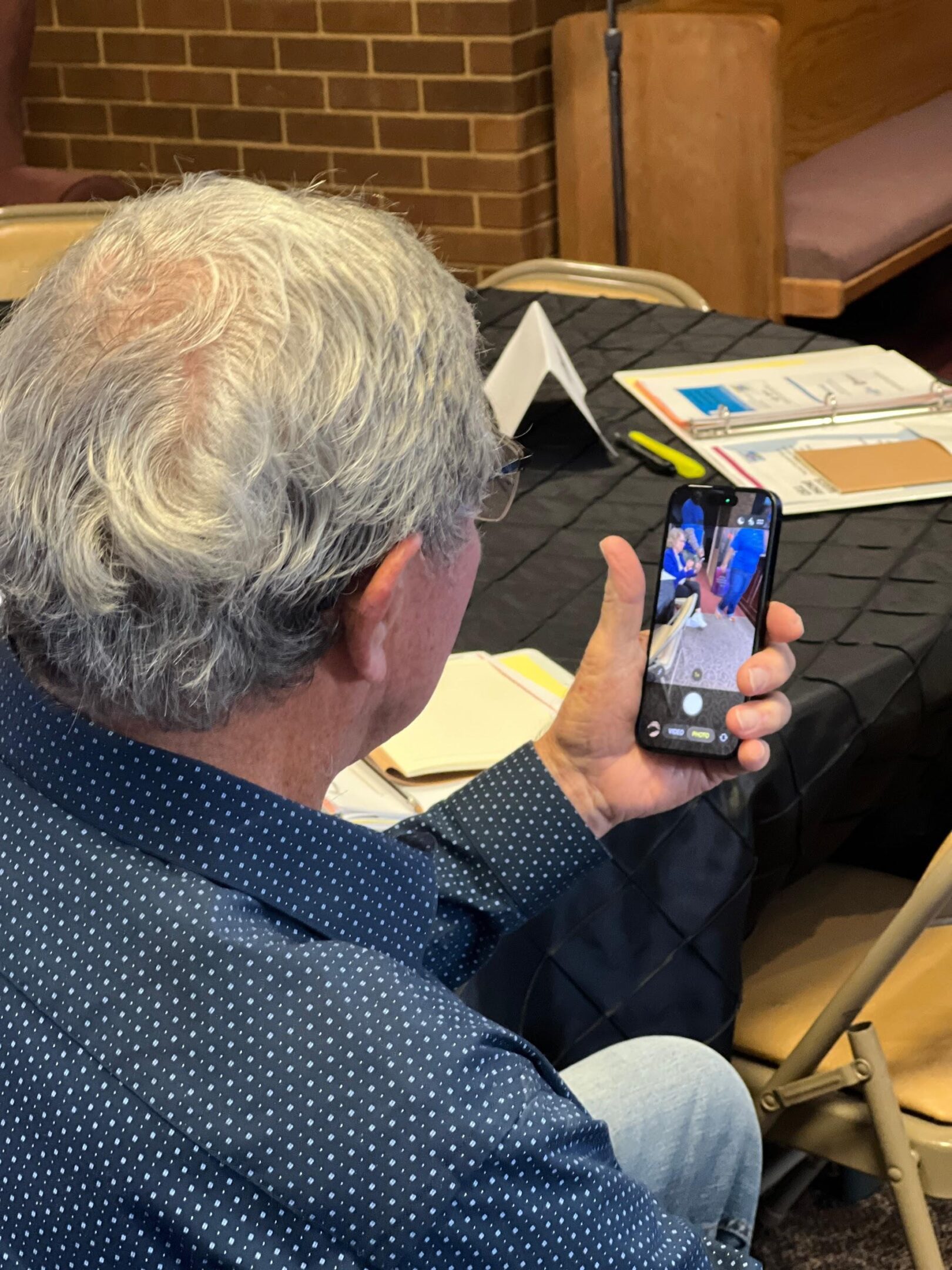 Man video calling on a smartphone indoors.