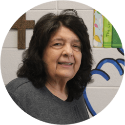 Smiling woman with dark hair in a casual setting.