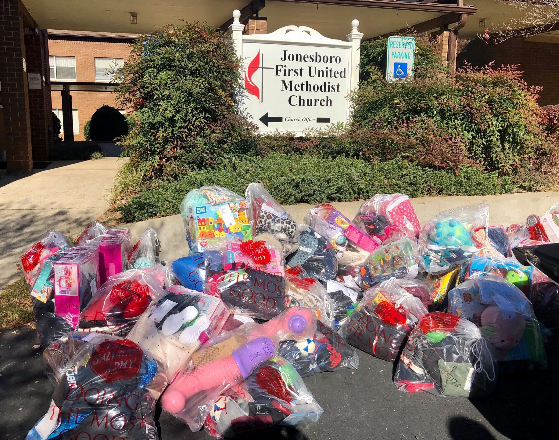 Large collection of donated clothing and items outside a church.